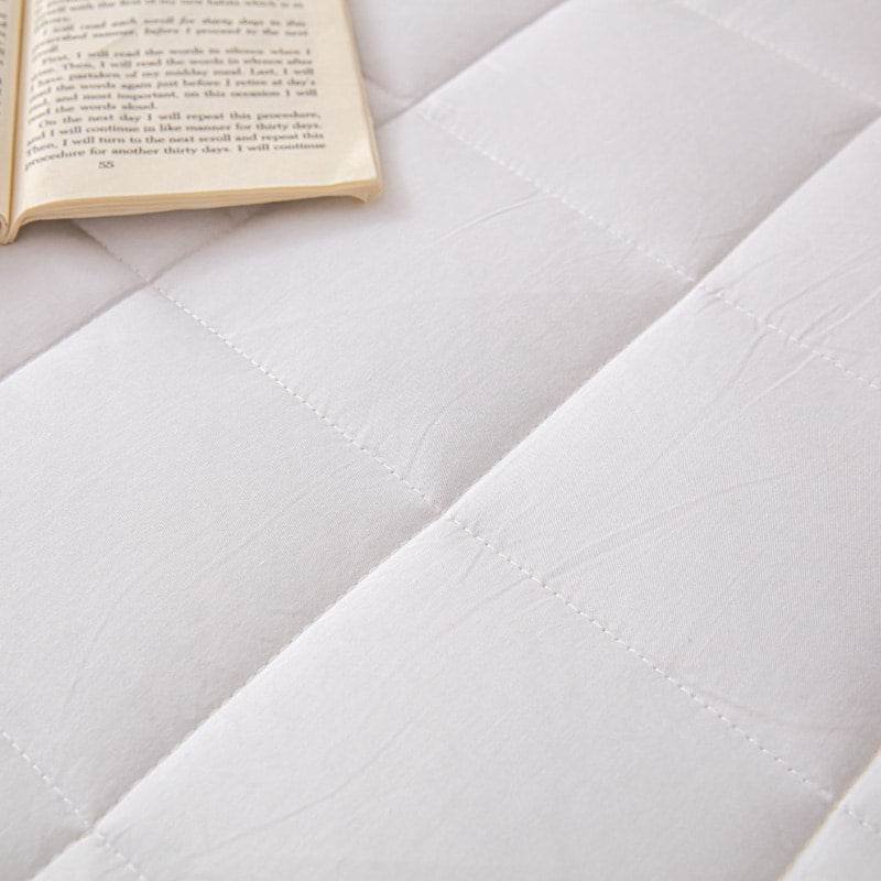 Calming heavy blanket styled on a modern sofa for home decor and comfort