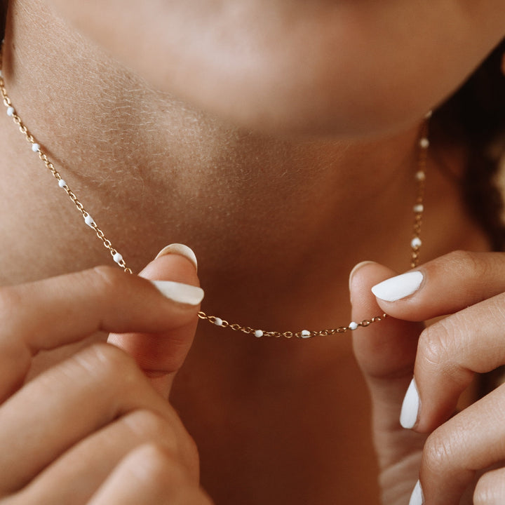 Hypoallergenic silver choker necklace styled with white enamel beads