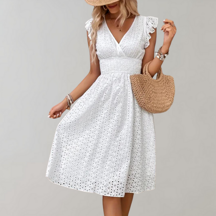 Full view of white summer dress with V-neckline and textured fabric