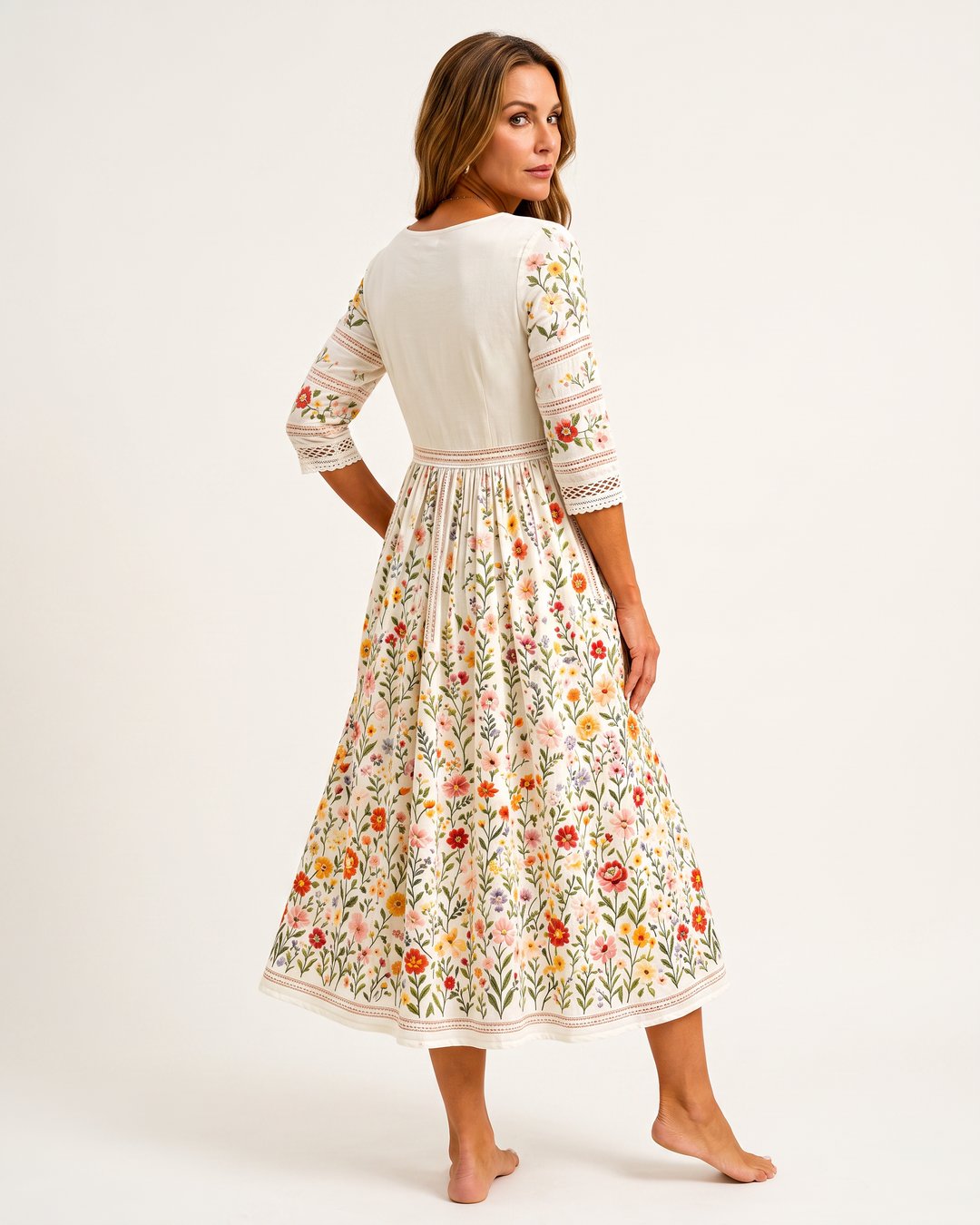 Back view of a woman modeling the floral meadow midi dress on a light background