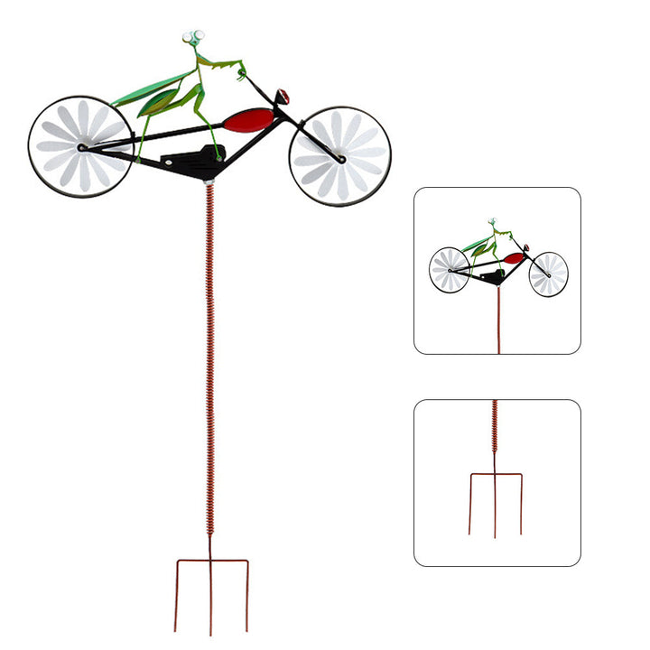 Kinetic garden stake with spinning blades adding motion to yard art