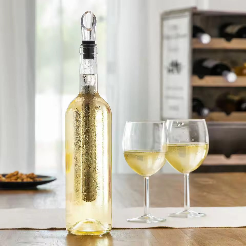 Bar accessory wine cooler stick resting next to a stemmed wine glass
