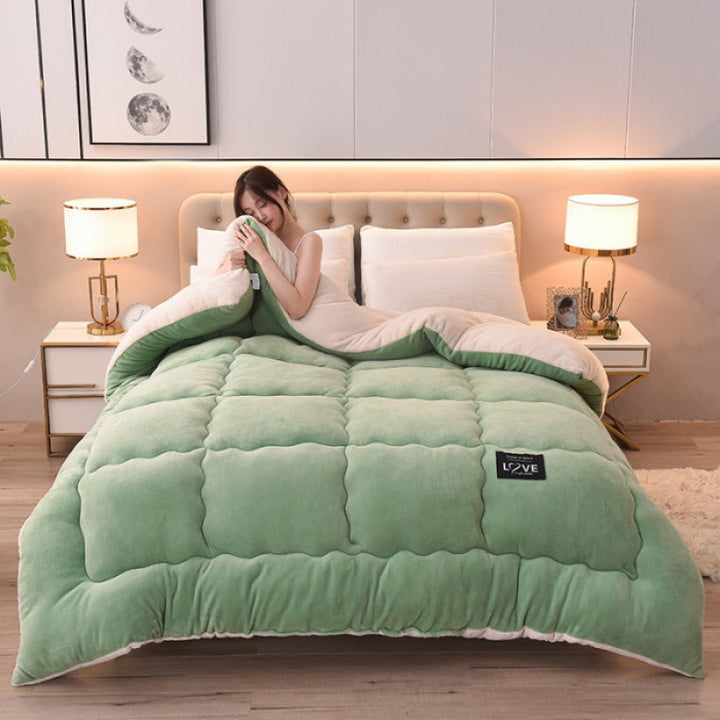 Avocado green winter duvet on a made bed with a woman resting