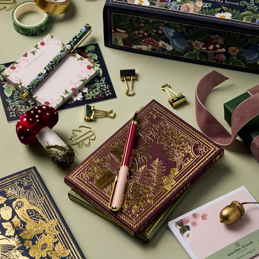 Winter pattern advent calendar box opened with stationery items laid out on a table