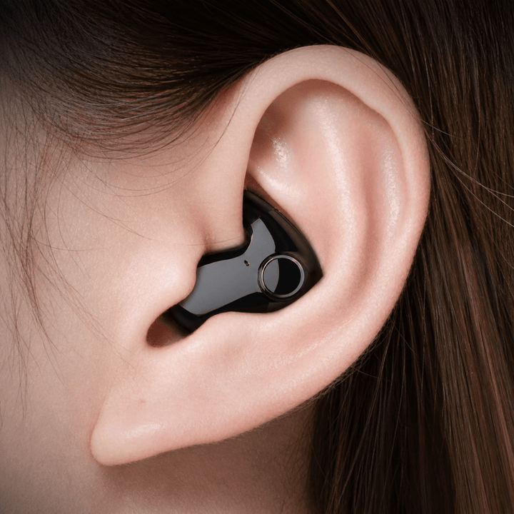 Close-up of black wireless earbud worn comfortably in the ear canal