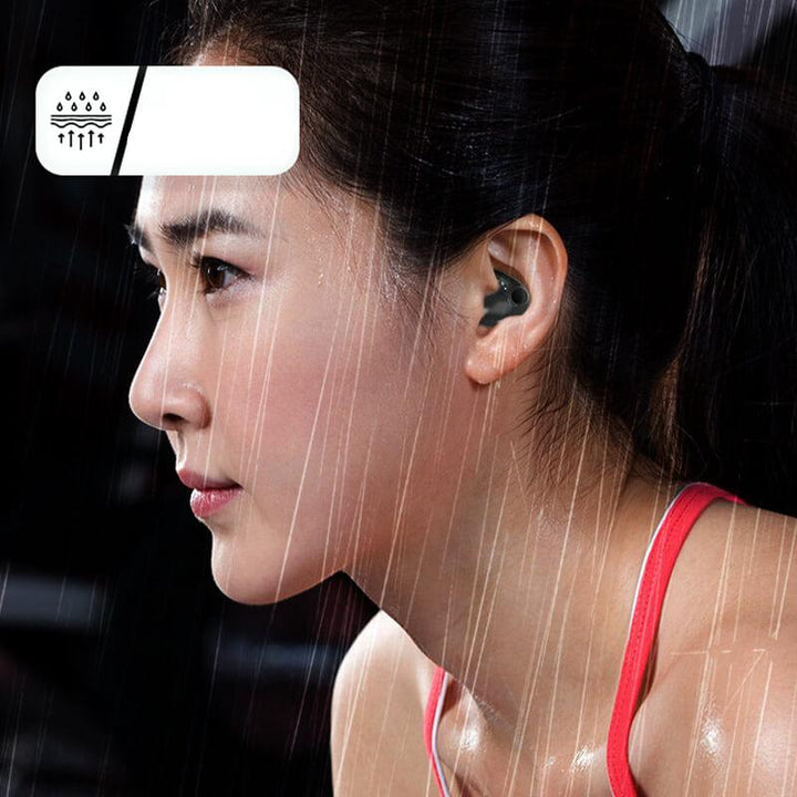 Woman wearing the wireless earbuds during a workout under rain