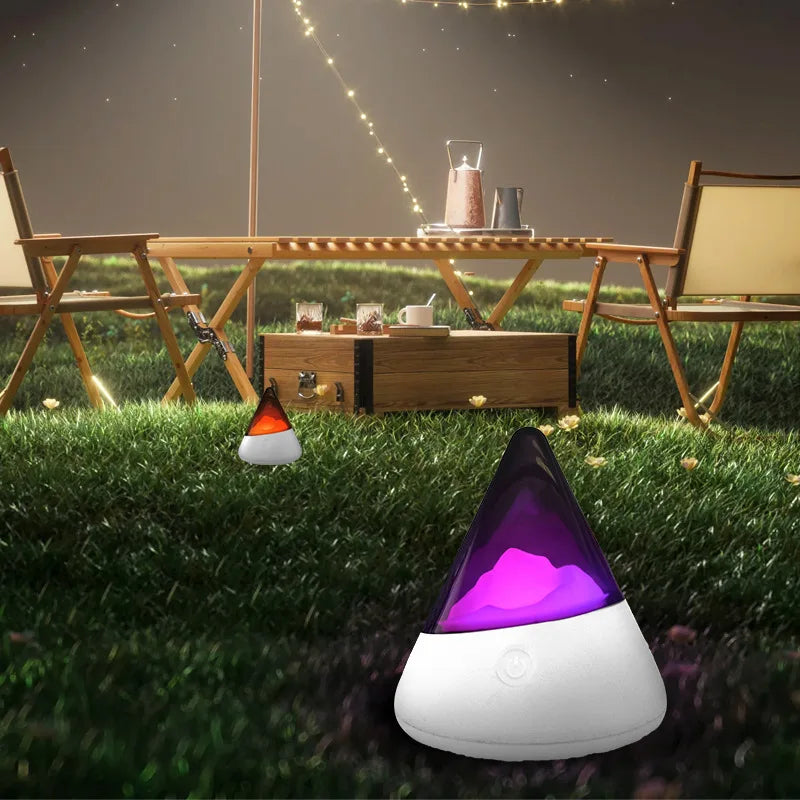 Portable LED night light illuminating an outdoor campsite table at night