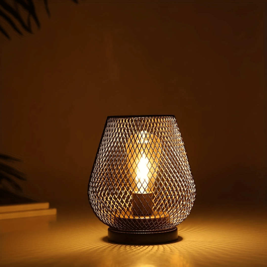 A single wireless LED lantern emitting a warm ambient glow in a dark room.