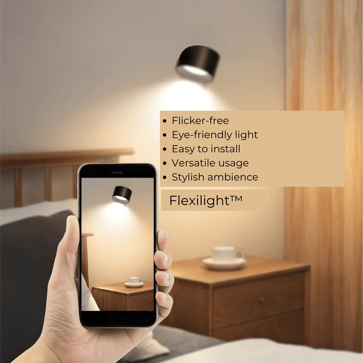 Cordless LED wall lamp demonstrating 360-degree rotation on wooden surface