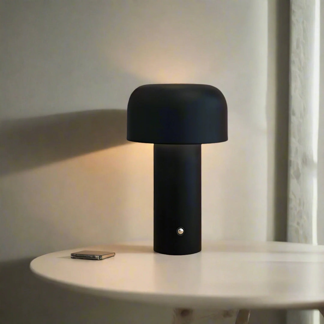Wireless metal table lamp emitting warm LED light in a cozy modern living room
