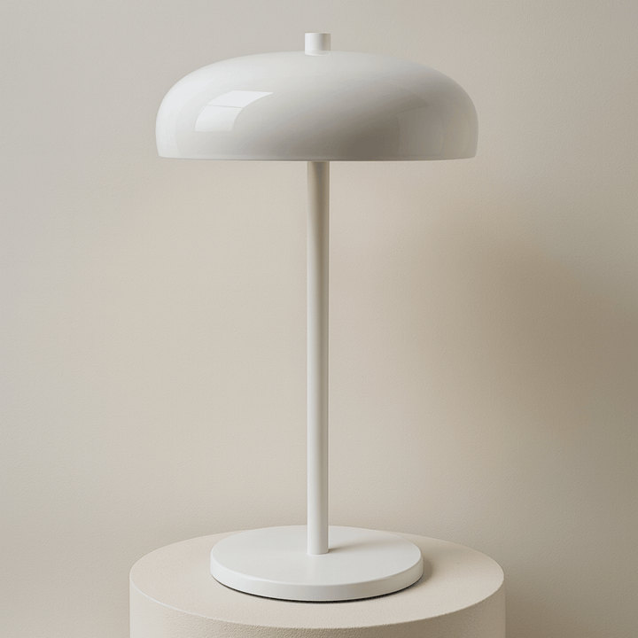 Modern white wireless table lamp on display pedestal