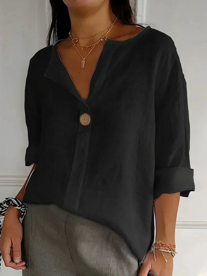 Close-up of buttons on stylish V-neck womens tunic shirt