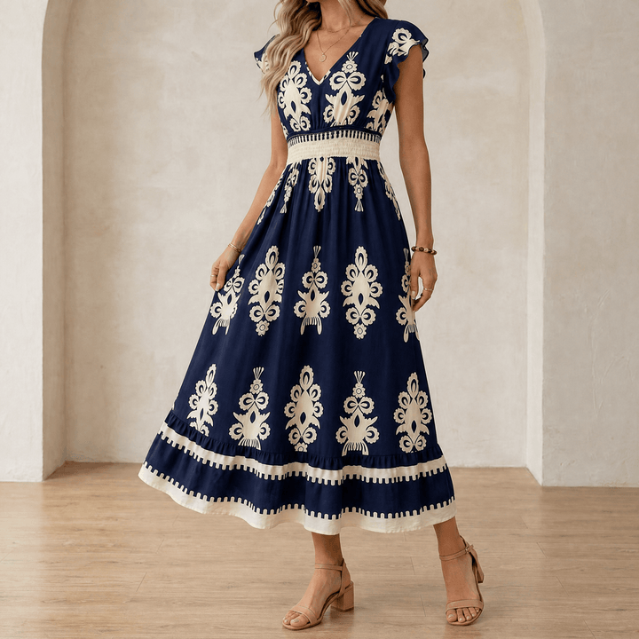 Woman wearing navy blue baroque print maxi dress with ruffles