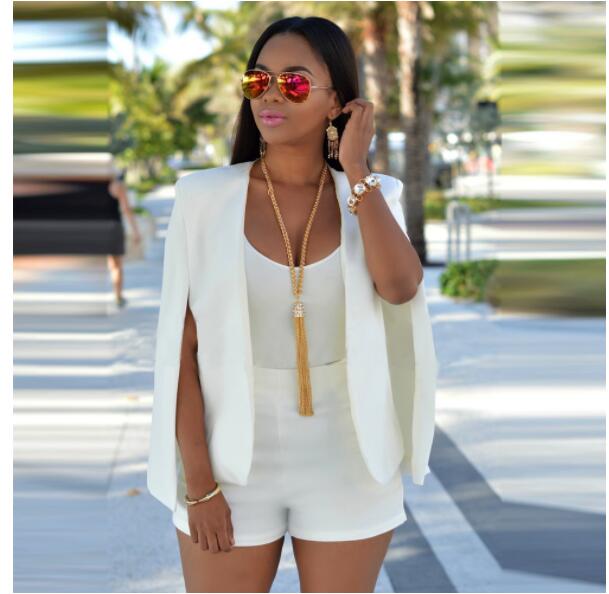 Woman wearing white elegant cape blazer coat