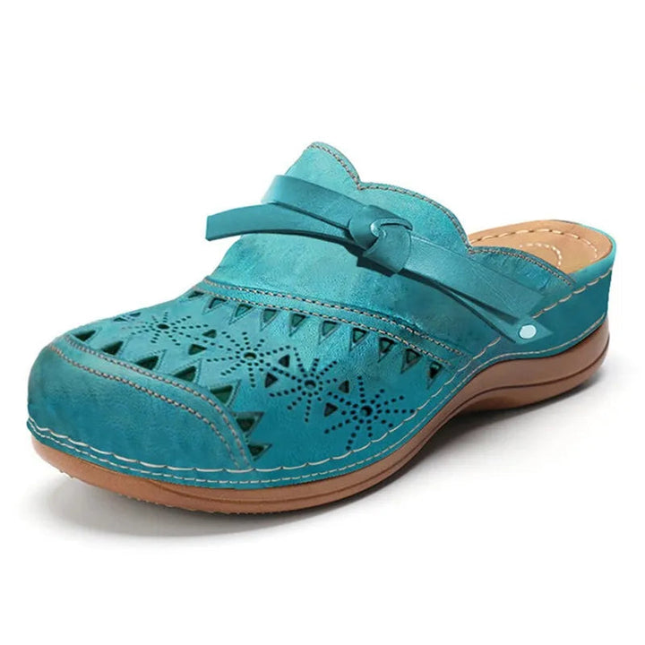 Casual summer footwear showing the side profile of cutout bow clogs