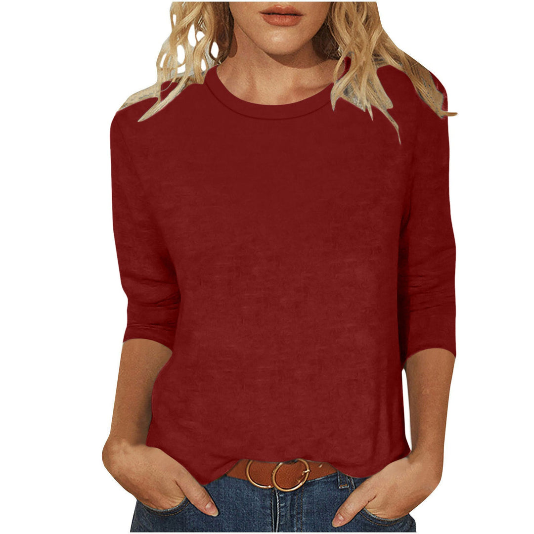 Flat lay of women's fashion casual top featuring 3/4 sleeves and comfortable fit