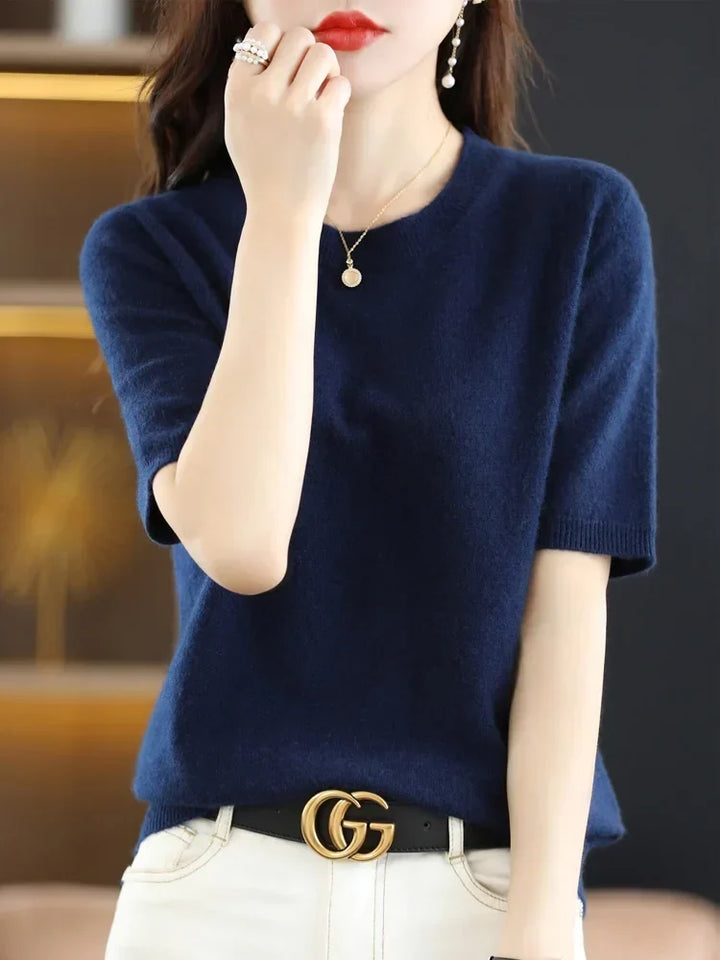 Flat lay of women's short sleeve crew neck knitted pullover sweater