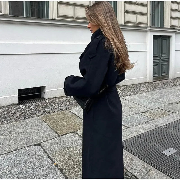 Close-up of the lapel and double-breasted button closure on a black trench coat