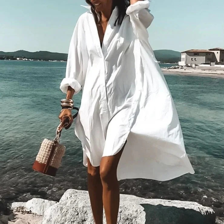 Woman wearing solid white long sleeve beach cover-up by the ocean