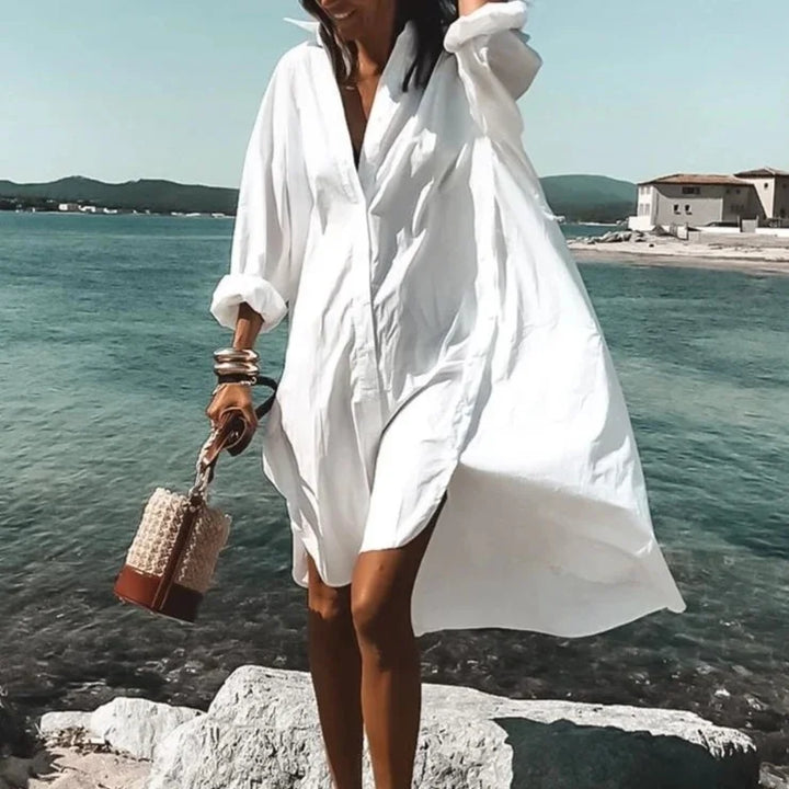 Woman wearing solid white long sleeve beach cover-up by the ocean