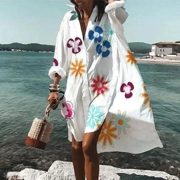 Close-up of fabric and buttons on a white womens beach cover-up shirt