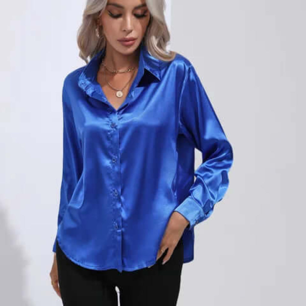Model wearing a royal blue loose fit long sleeve satin blouse