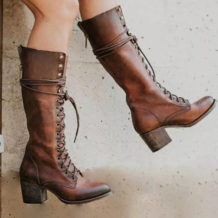 Brown lace-up combat boots featuring side zipper and decorative ankle strap