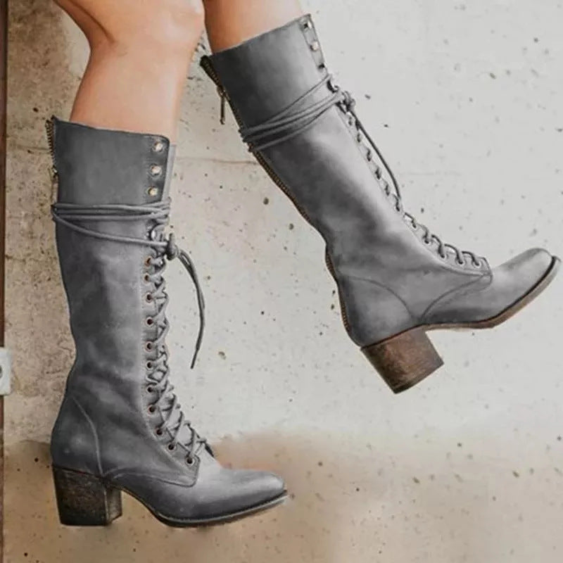 Grey mid-calf lace-up boots shown from the side against a neutral backdrop