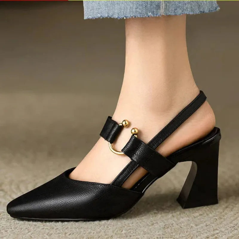Black orthopedic supportive high heels worn on foot