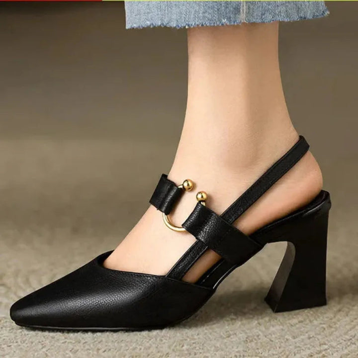 Black orthopedic supportive high heels worn on foot