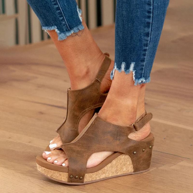 Pair of casual summer wedge sandals with adjustable straps on white background