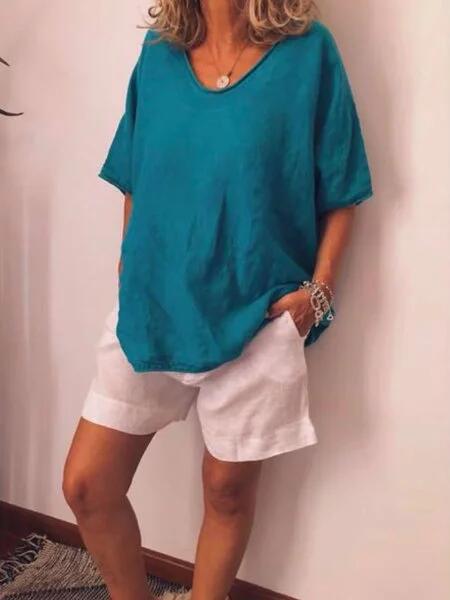 Woman wearing blue relaxed fit summer top with shorts