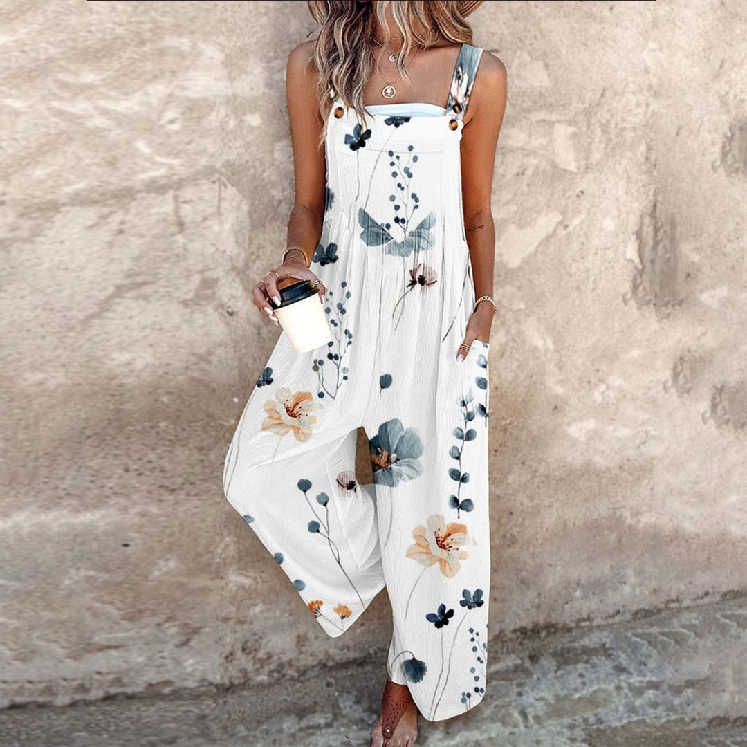 Woman wearing white sleeveless floral maxi jumpsuit with wide legs