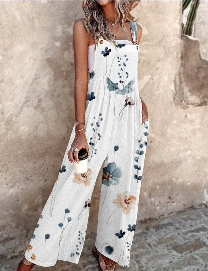 Close-up view of woman wearing white sleeveless floral maxi jumpsuit