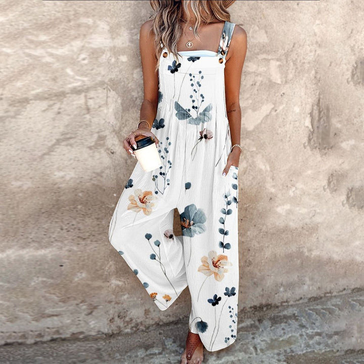 Woman posing in a white vintage floral print sleeveless jumpsuit outdoors