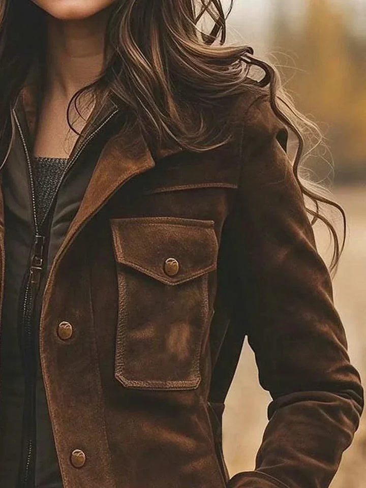 Close-up of the buttoned chest pocket and lapel collar on the brown women's jacket