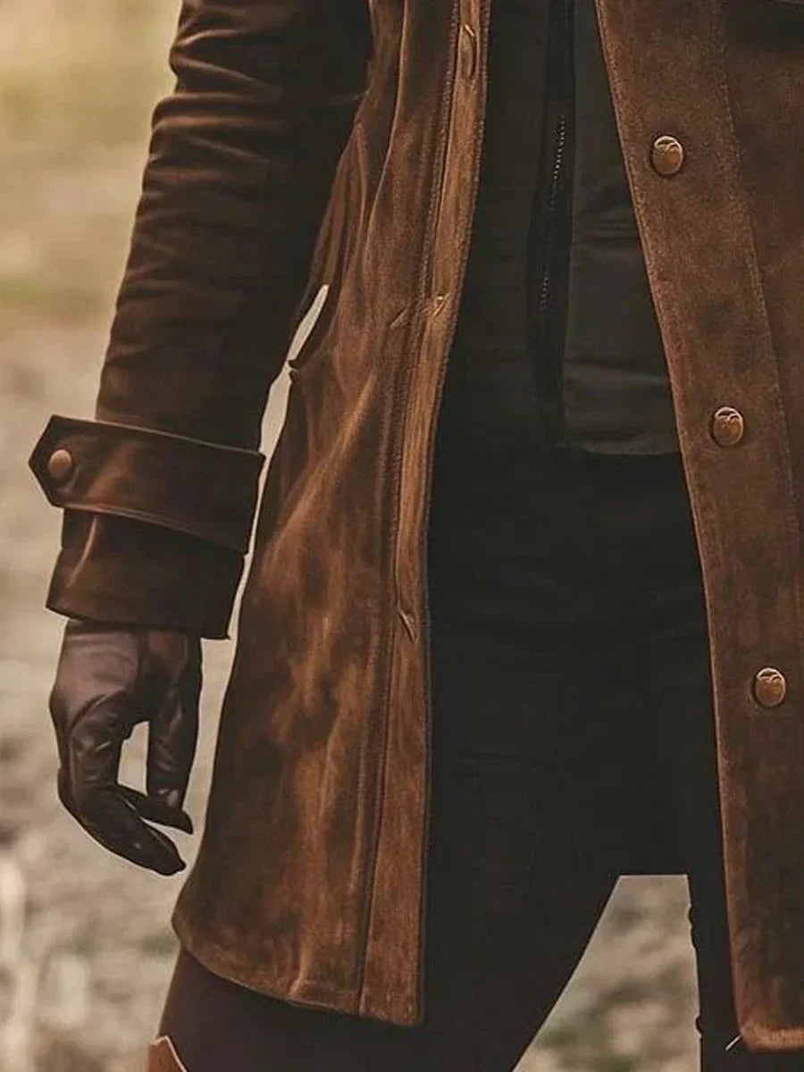 Close-up of the buttoned sleeve cuff and hemline on the brown jacket