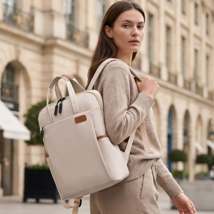 Woman wearing cream anti-theft travel backpack on a city street