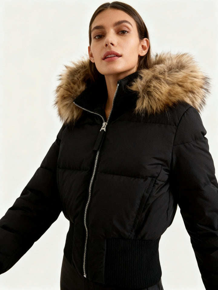 Model wearing a black quilted winter puffer jacket with faux fur hood