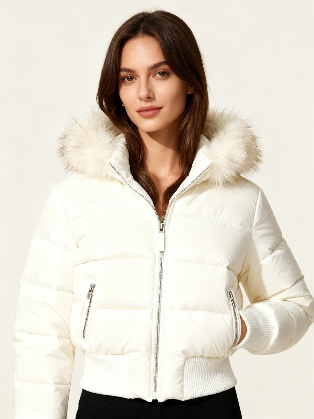 Model wearing a white quilted winter puffer jacket with faux fur hood