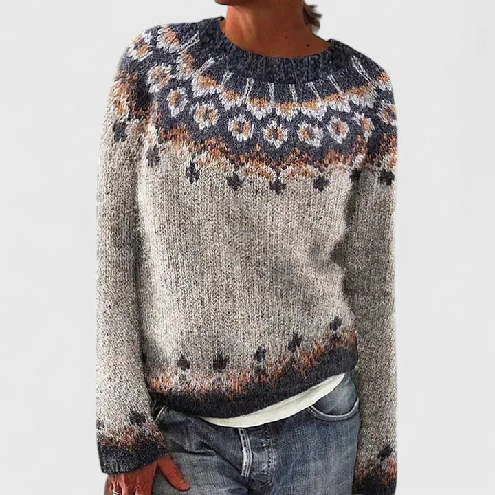 Woman wearing a dark gray patterned knit pullover sweater