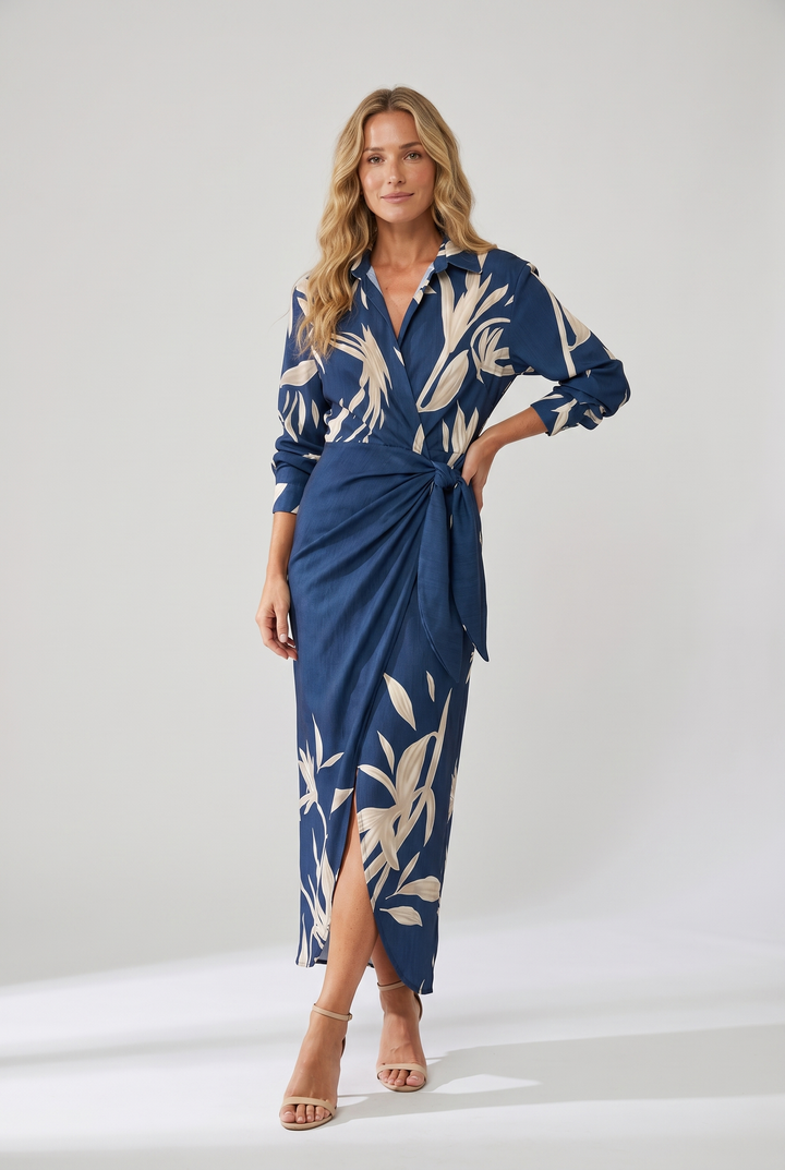 Full-body view of a model standing in a blue botanical print midi dress