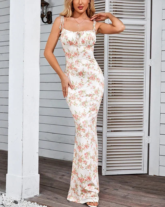Model wearing pink floral maxi dress with adjustable shoulder ties