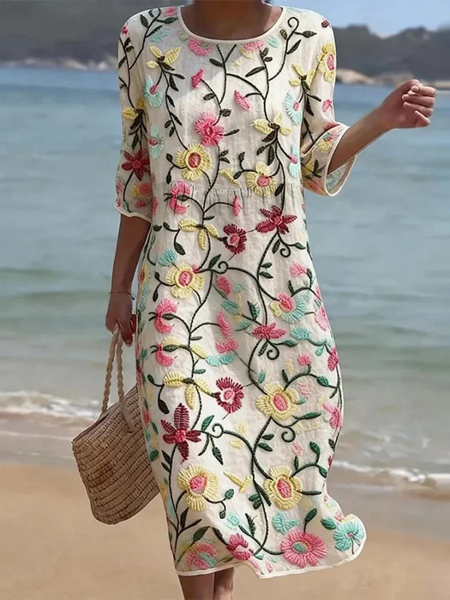 Woman wearing a floral midi dress with bell sleeves on a beach