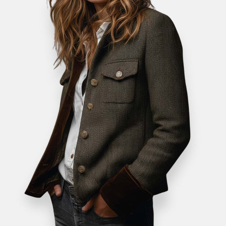 Side profile view of the tailored brown herringbone blazer with chest pockets