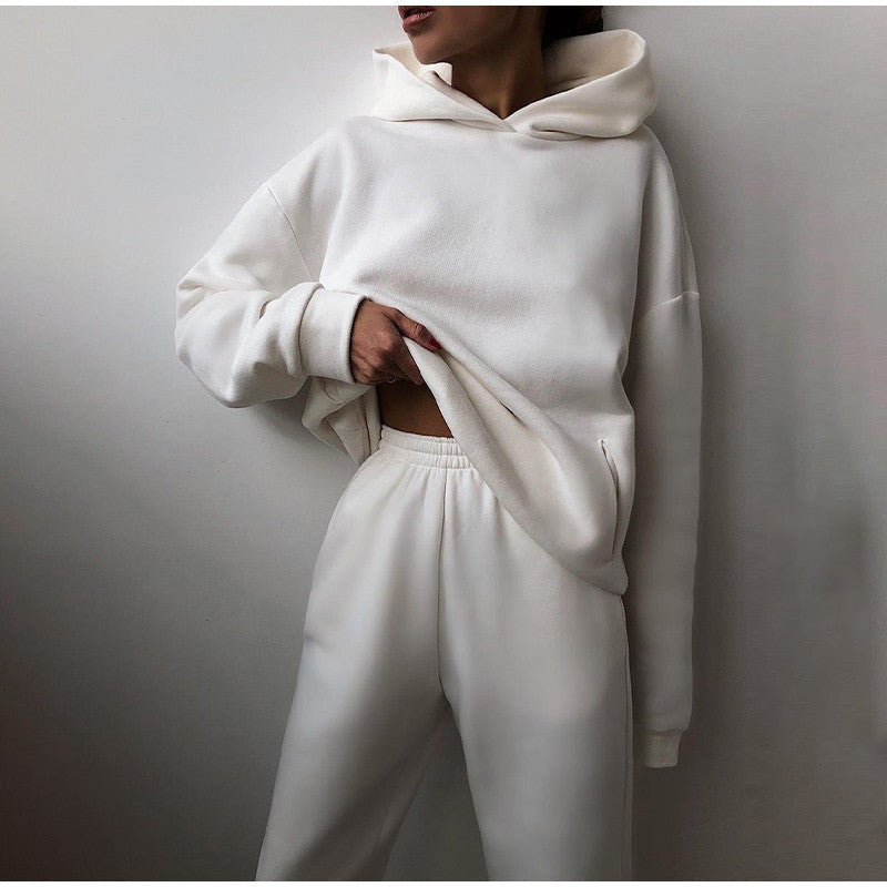 Woman posing in a clean white oversized hoodie and matching lounge pants set