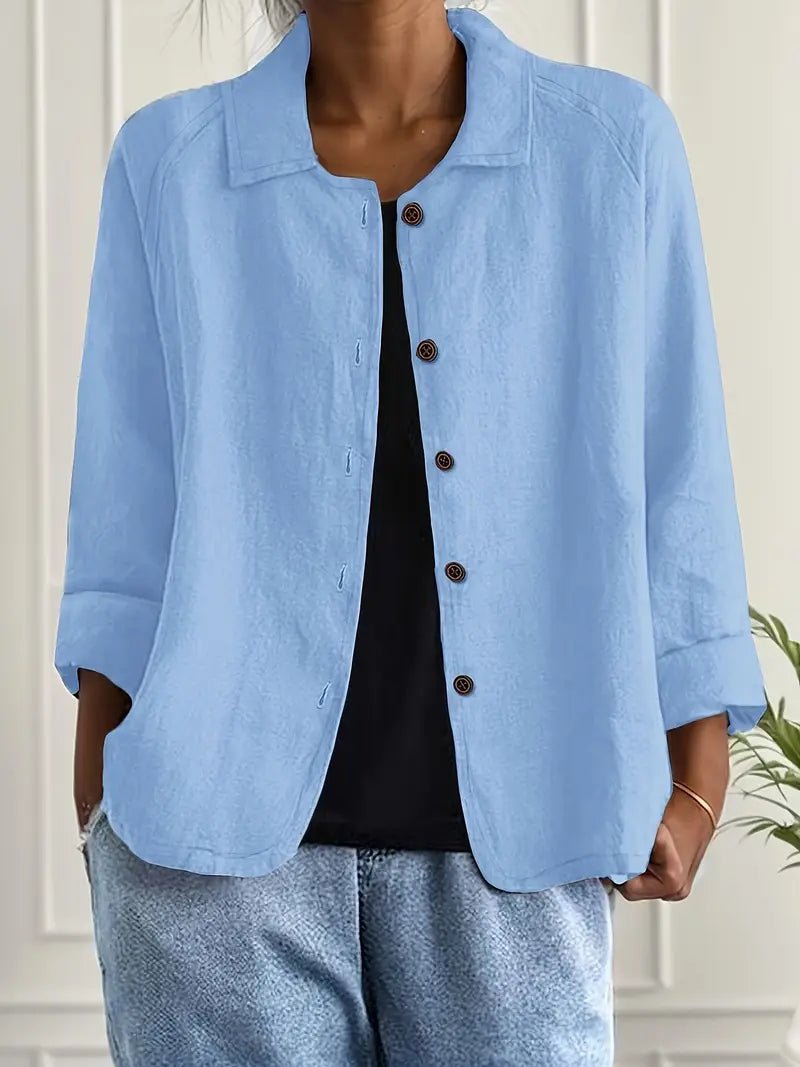 Woman wearing a light blue lightweight button front jacket over a black top