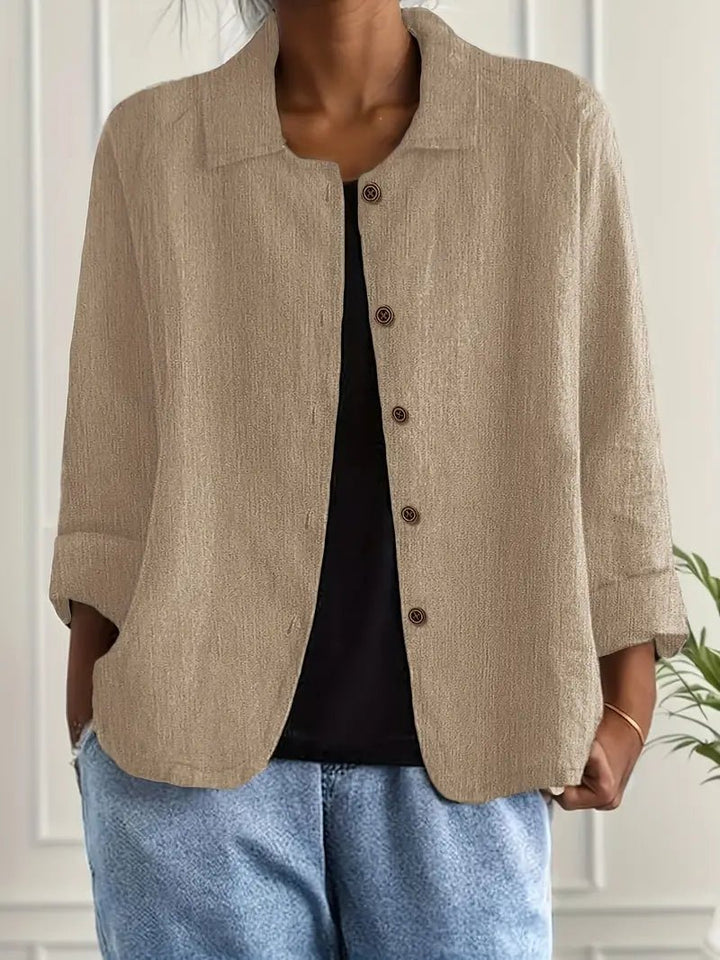 Woman wearing a khaki lightweight button front jacket over a black top