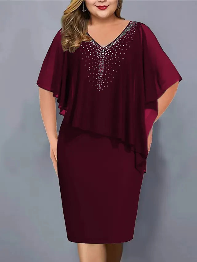 Plus size woman wearing burgundy midi dress with chiffon cape and rhinestone V-neck