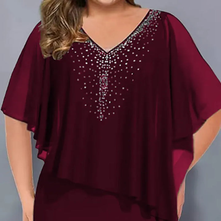 Side angle of a sophisticated evening midi dress with a lightweight chiffon overlay design
